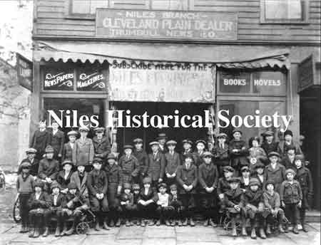 The photograph on the left shows the newsboys in front of the newstand where the Harris House was located.