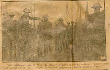 Ohio militiamen march through the streets of Niles in riot formation, lining up in the V-shaped formation, preparing to march down a street.