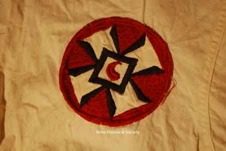 Close-up of Klan emblem worn on robe.