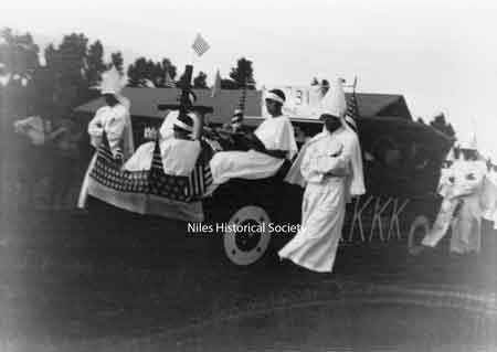 The Klan parades usually had robed men, women and children march along cars decorated with the American flag and KKK insignias.