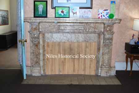 Marble fireplace in living room.