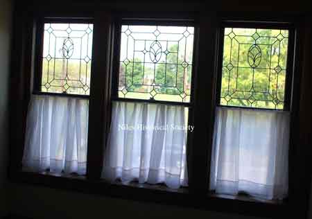 Cut glass windows at the top of the first floor stairway landing.