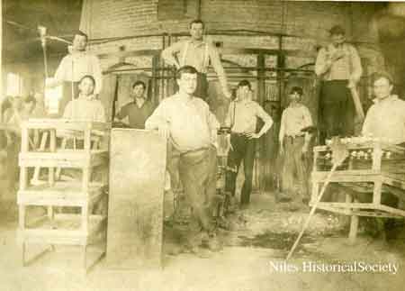 Glass blowers on pedestal mould