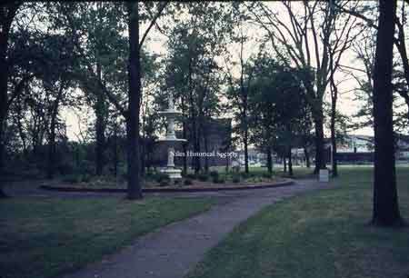View of fountain in Central Park. The wading pool has been filled in with plantings.