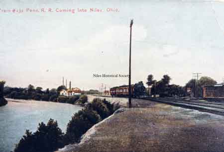 From South Main Street looking west. Note water works in the background on left. Passenger train is on the Pennsylvania RR coming into Niles.