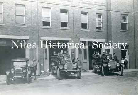 The Fire Chief's car and two fire trucks leaving the fire station on a 'call'.