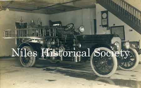 Niles Fire engine #1 inside fire station. Note the Dayton Tubeless tires on the front wheels and the tire chains on the outside of the double-tired back wheels.