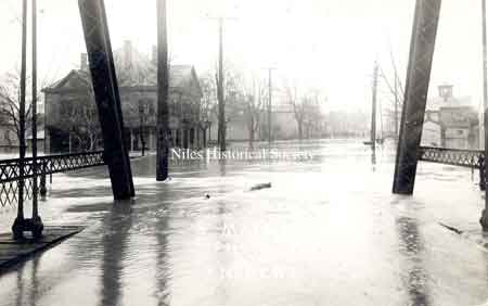 Postcard view of the 1913 flood that created havoc up and down the state. Taken from the Main Street bridge over the Mahoning River facing south. The building at the upper right is the Eagles Lodge building.
