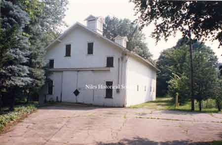 View of the white barn with cupolas