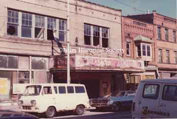 The Warner Theater fell into disrepair as evidenced by the photographs taken in 1975; later the building was demolished in 1976 during urban renewal.