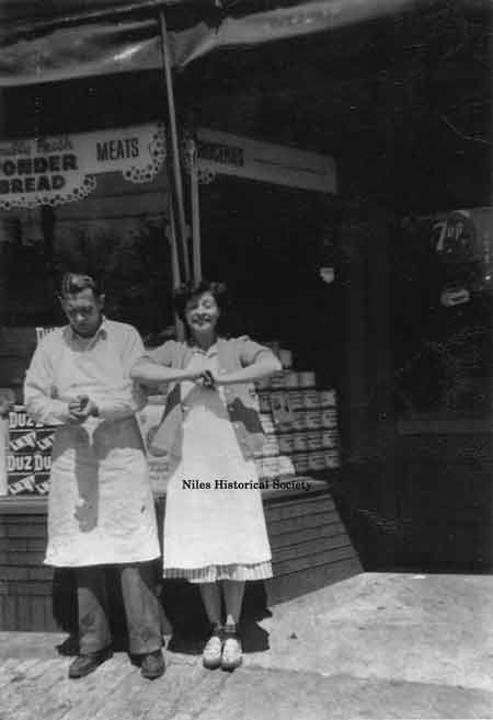 William and Audrey Nicholas in front of the Nicholas Market at 1328 Robbins Avenue.