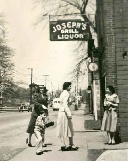 View looking north on Main Street with the railroad crossing watch tower in the background and Joseph's Grill in the foreground.