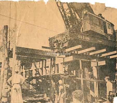 Scaffolding erected to allow the railroad crane to lift support beams into place.