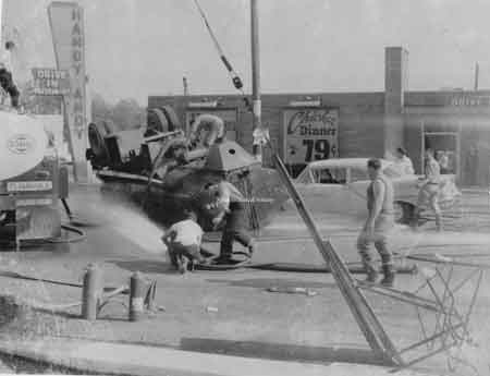 Truck crash in front of Handy Andy's restaurant with the sign visible on left.