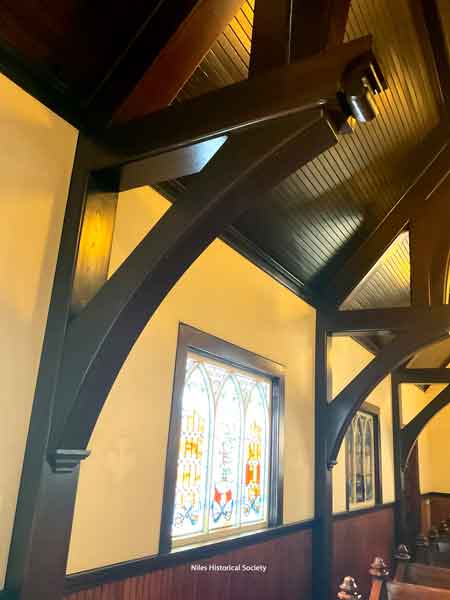 Wooden support arches and ceiling.