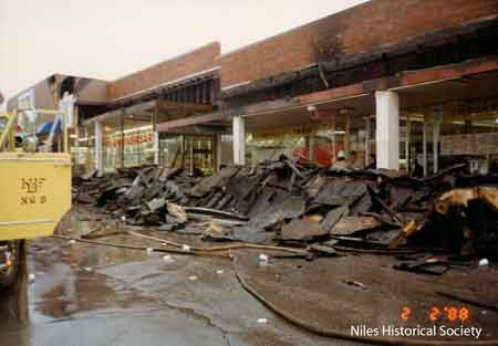 View of fire damage to Thrift Drug and CeConi's stores at Niles Plaza.