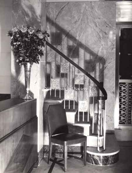 Photograph of the interior staircase leading up to the balcony from the main lobby of the Niles Trust Company on opening day.