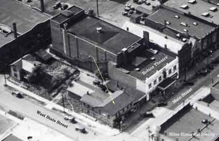 1930 aerial view of the building and home located on site at the northwest corner of State Street and Main Street.