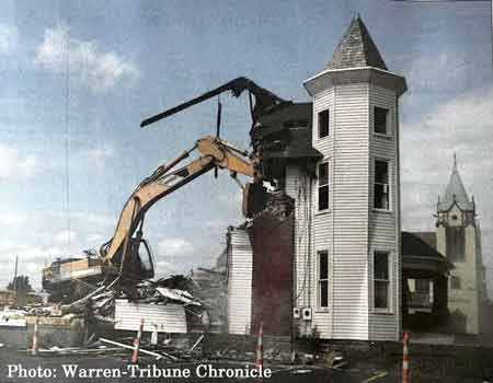 Boccia Demolition workers, Richard Boccia and Terry Dickson, tear down the former Lane Funeral Home's Robbins Avenue location in Niles.