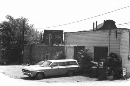 Side view of Sammy Bernard’s Arco gas station located on Pine Alley before urban renewal.