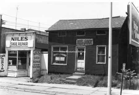 Photo taken of Niles Shoe Repair and Niles Chinese Laundry located at 130 and 132 East State Street in downtown Niles before urban renewal.