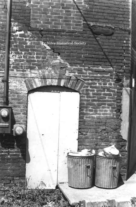 Photo taken of rear facade of unidentified building located on the east side of East State Street (over Mosquito Creek) in downtown Niles before urban renewal.