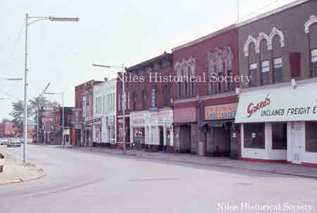 Looking north from the curve on East State Street. Grand’s Unclaimed Freight, Bahm’s Shoe Center, Gerke Radio & Television, Joe Antenucci Plumbing, Antique Shop, Valsi Cleaners, Lou Carbone Plumbing, and Fusco Dry Cleaners.