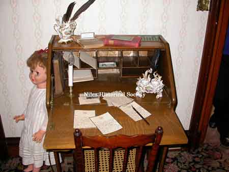 Child's desk with writing tools.